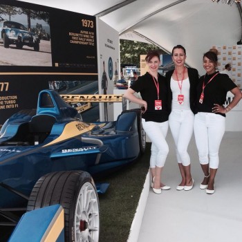 Motorsport promotional staff in white and black uniform