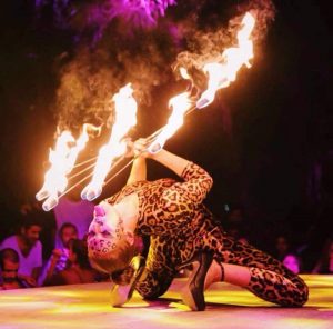 Fire dancer performing on stage in Leopard costume